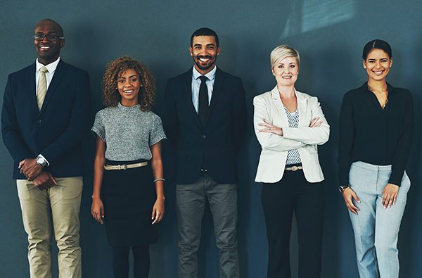 Employees standing together smiling