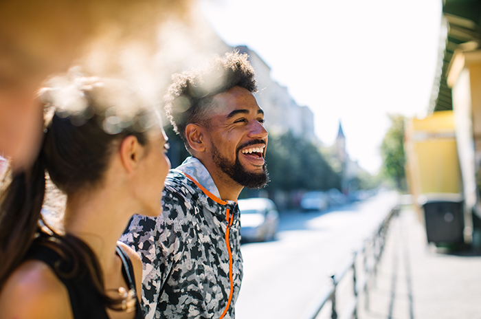 Friends walking down the street smiling