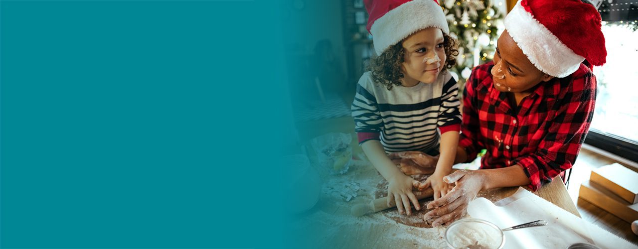 Mother and child wearing Christmas Hats and Baking